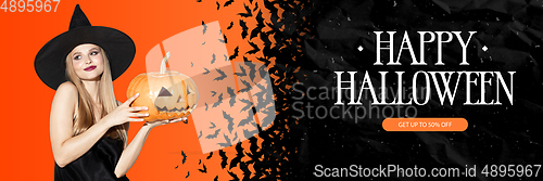 Image of Young woman in hat as a witch on scary orange and black background