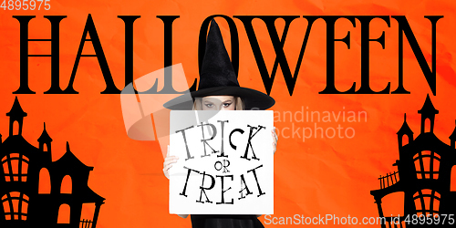 Image of Young woman in hat as a witch on scary orange background