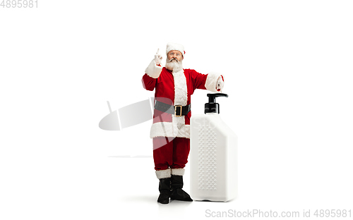 Image of Santa Claus with the huge antiseptics against COVID like Christmas gift isolated on white background