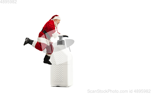 Image of Santa Claus with the huge antiseptics against COVID like Christmas gift isolated on white background