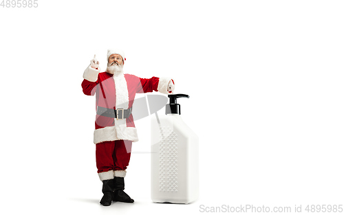 Image of Santa Claus with the huge antiseptics against COVID like Christmas gift isolated on white background