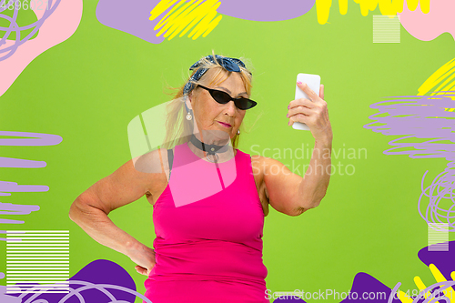 Image of Senior hipster woman using devices, gadgets. Tech and joyful elderly lifestyle concept. Bright illustrated background