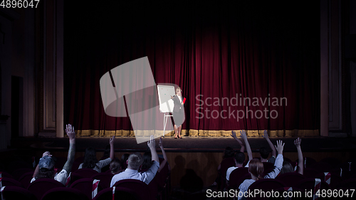 Image of Female caucasian speaker giving presentation in hall at university or business centre workshop