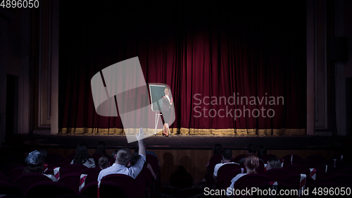 Image of Female caucasian speaker giving presentation in hall at university or business centre workshop