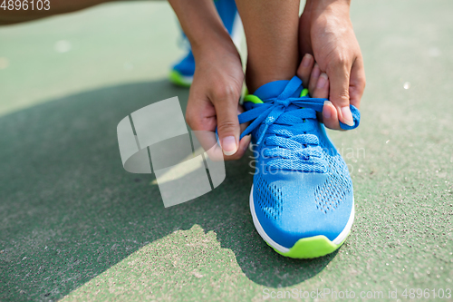 Image of Woman trying the shoelace