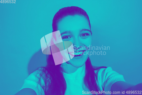 Image of Close up portrait of caucasian girl isolated on studio background. Modern and trendy duotone effect