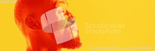 Image of Close up portrait of african man isolated on studio background. Modern and trendy duotone effect