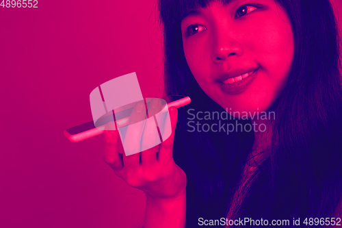 Image of Close up portrait of woman isolated on studio background. Modern and trendy duotone effect