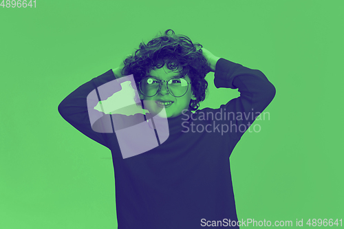 Image of Close up portrait of caucasian boy isolated on studio background. Modern and trendy duotone effect