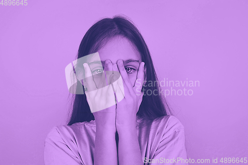 Image of Close up portrait of caucasian girl isolated on studio background. Modern and trendy duotone effect