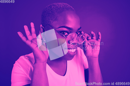 Image of Close up portrait of african woman isolated on studio background. Modern and trendy duotone effect