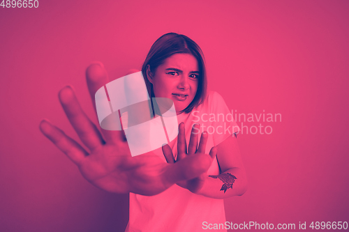 Image of Close up portrait of caucasian woman isolated on studio background. Modern and trendy duotone effect