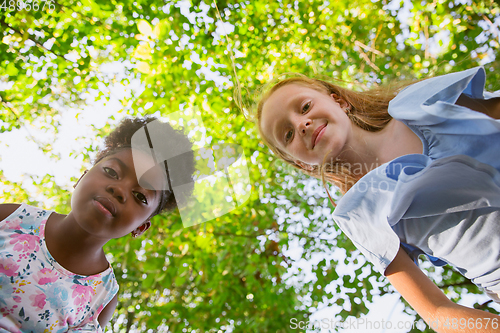 Image of Interracial kids, friends, girls playing together at the park in summer day