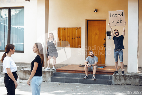 Image of Dude with sign - man stands protesting things that annoy him