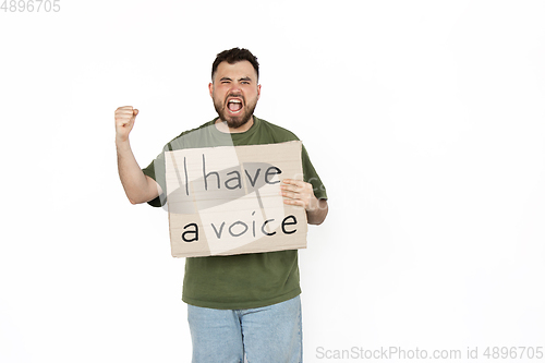 Image of Young man protesting isolated on white studio background. Activism, active social position, protest, actual problems.