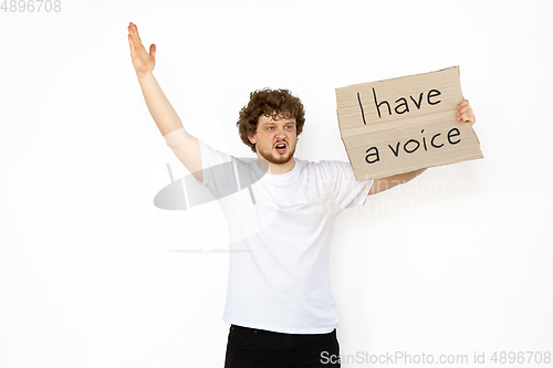 Image of Young man protesting isolated on white studio background. Activism, active social position, protest, actual problems.