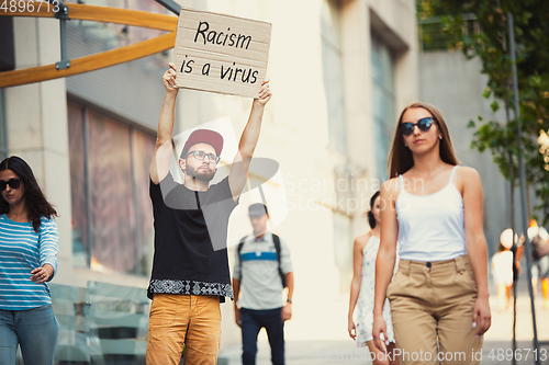 Image of Dude with sign - man stands protesting things that annoy him