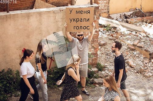 Image of Dude with sign - man stands protesting things that annoy him