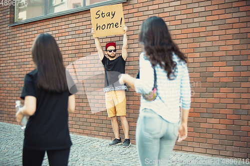 Image of Dude with sign - man stands protesting things that annoy him