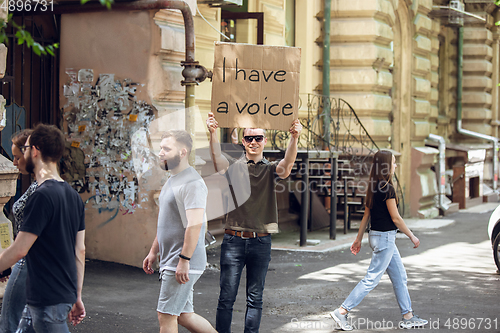 Image of Dude with sign - man stands protesting things that annoy him