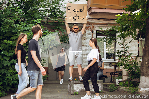 Image of Dude with sign - man stands protesting things that annoy him