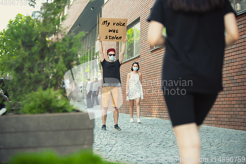 Image of Dude with sign - man stands protesting things that annoy him