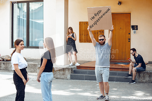 Image of Dude with sign - man stands protesting things that annoy him