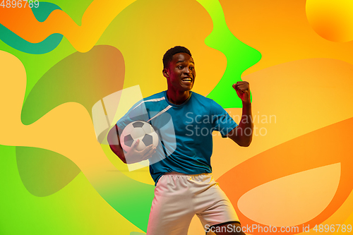 Image of African soccer, football player portrait isolated on bright, modern illustrated background.