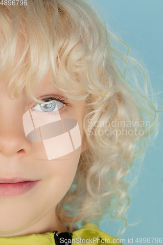 Image of Portrait of beautiful caucasian little boy isolated on blue studio background
