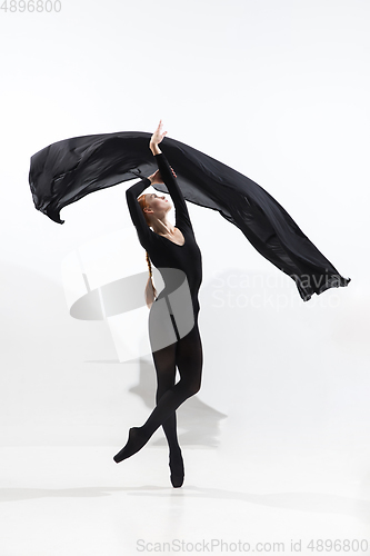 Image of Young and graceful ballet dancer in minimal black style isolated on white studio background