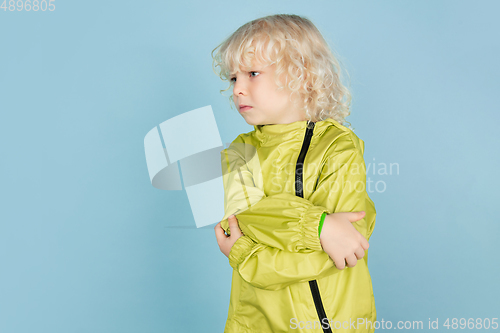 Image of Portrait of beautiful caucasian little boy isolated on blue studio background