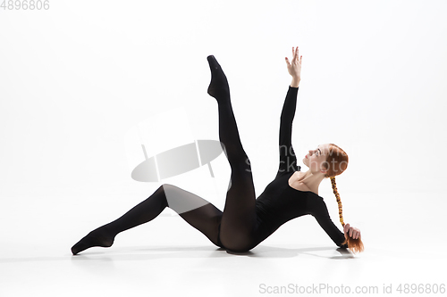 Image of Young and graceful ballet dancer in minimal black style isolated on white studio background