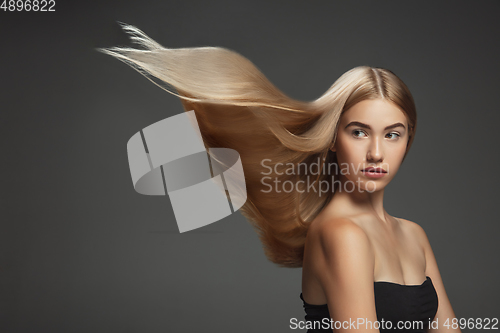 Image of Beautiful model with long smooth, flying blonde hair