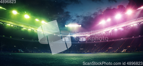Image of Full stadium and neoned colorful flashlights background