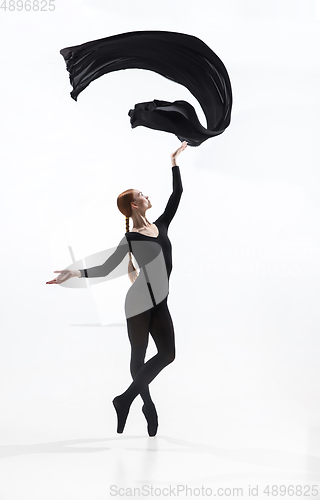 Image of Young and graceful ballet dancer in minimal black style isolated on white studio background