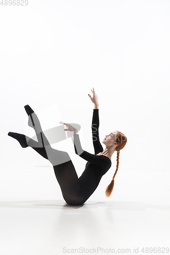 Image of Young and graceful ballet dancer in minimal black style isolated on white studio background