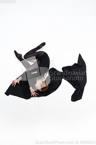 Image of Young and graceful ballet dancer in minimal black style isolated on white studio background