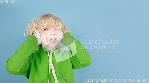 Image of Portrait of beautiful caucasian little boy isolated on blue studio background