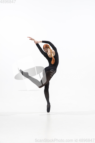 Image of Young and graceful ballet dancer in minimal black style isolated on white studio background