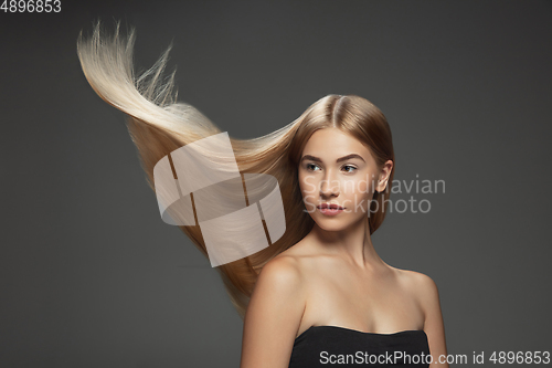 Image of Beautiful model with long smooth, flying blonde hair