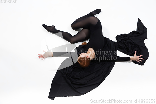 Image of Young and graceful ballet dancer in minimal black style isolated on white studio background