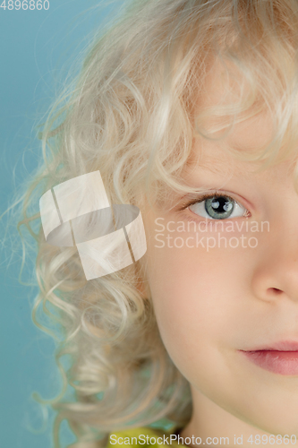 Image of Portrait of beautiful caucasian little boy isolated on blue studio background