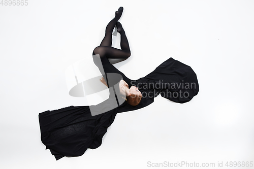 Image of Young and graceful ballet dancer in minimal black style isolated on white studio background