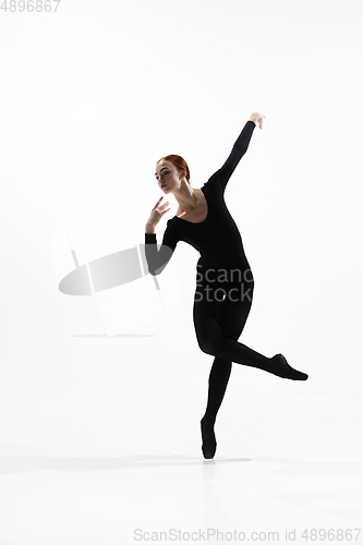 Image of Young and graceful ballet dancer in minimal black style isolated on white studio background