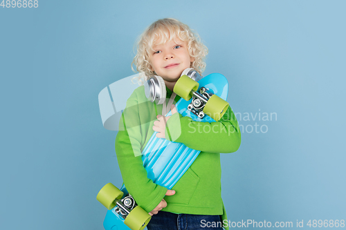 Image of Portrait of beautiful caucasian little boy isolated on blue studio background