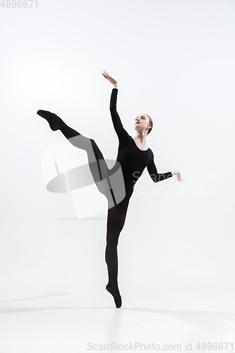 Image of Young and graceful ballet dancer in minimal black style isolated on white studio background