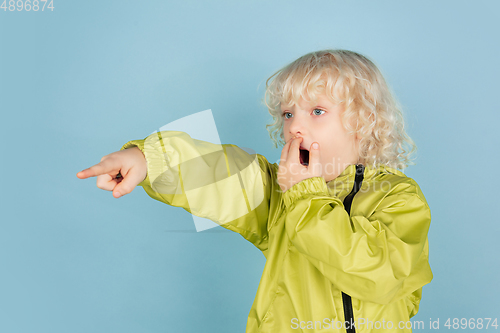 Image of Portrait of beautiful caucasian little boy isolated on blue studio background