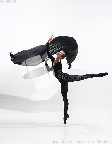 Image of Young and graceful ballet dancer in minimal black style isolated on white studio background