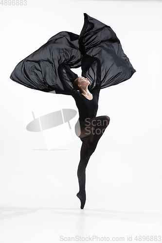 Image of Young and graceful ballet dancer in minimal black style isolated on white studio background