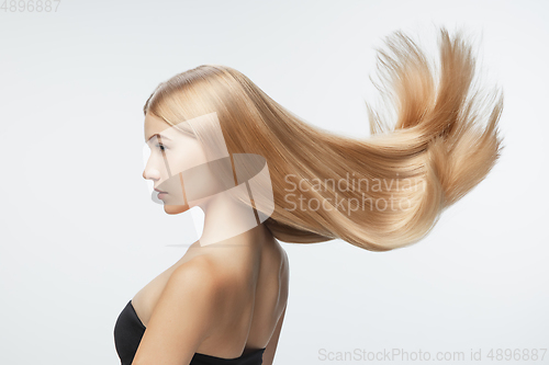 Image of Beautiful model with long smooth, flying blonde hair